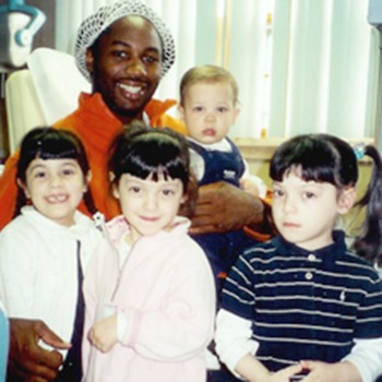 Lennox Lewis posing with Dr. DeMartino's children