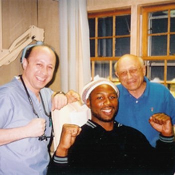Dr. DeMartino and his father posing with Lennox Lewis