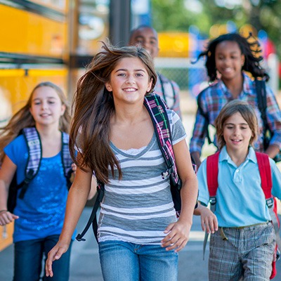 Group of kids by school bus