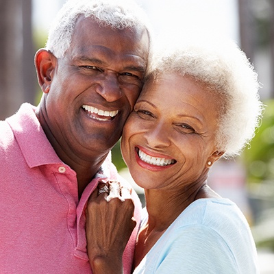 Smiling older man and woman outdoors