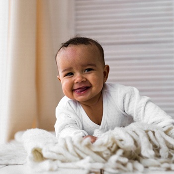 A baby sticking its tongue out