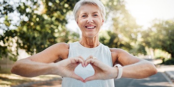 Lady makes shape of heart with her hands