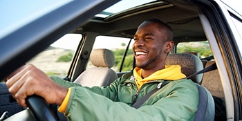 Man smiles while driving