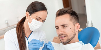 Dentist shows patient clear aligners