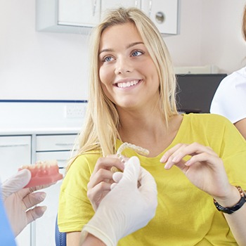 Woman holding invisalign tray