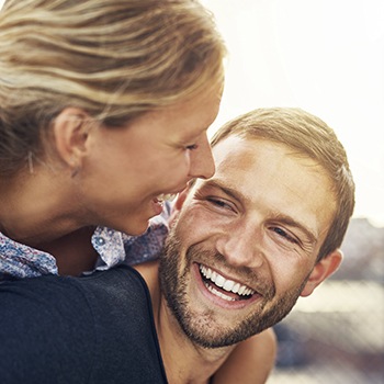 Man and woman smiling outdoors