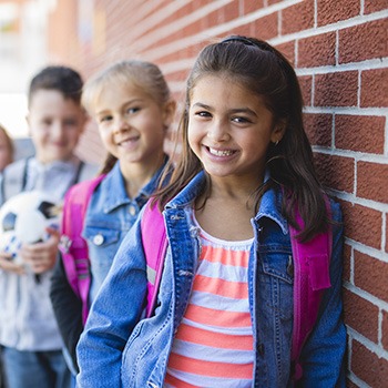 Three children smiling together