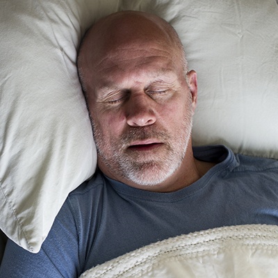 Man sleeping soundly in bed