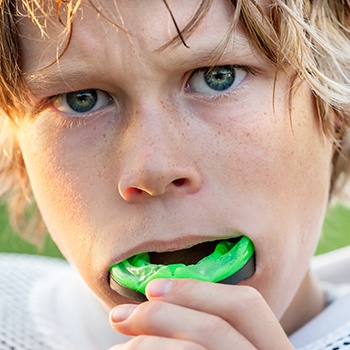 Teen boy placing green sportsguard