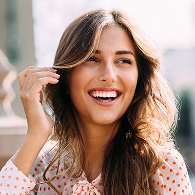 Young woman smiling outdoors